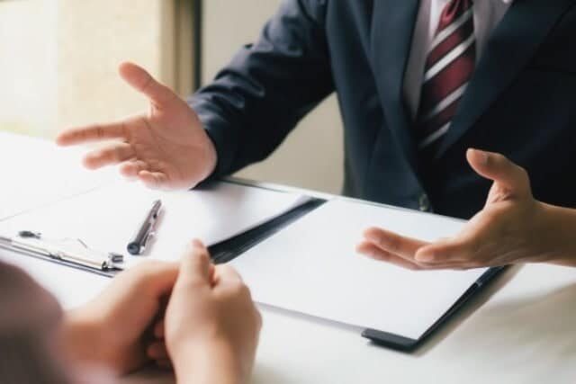 a lawyer explaining their medical malpractice case to a client